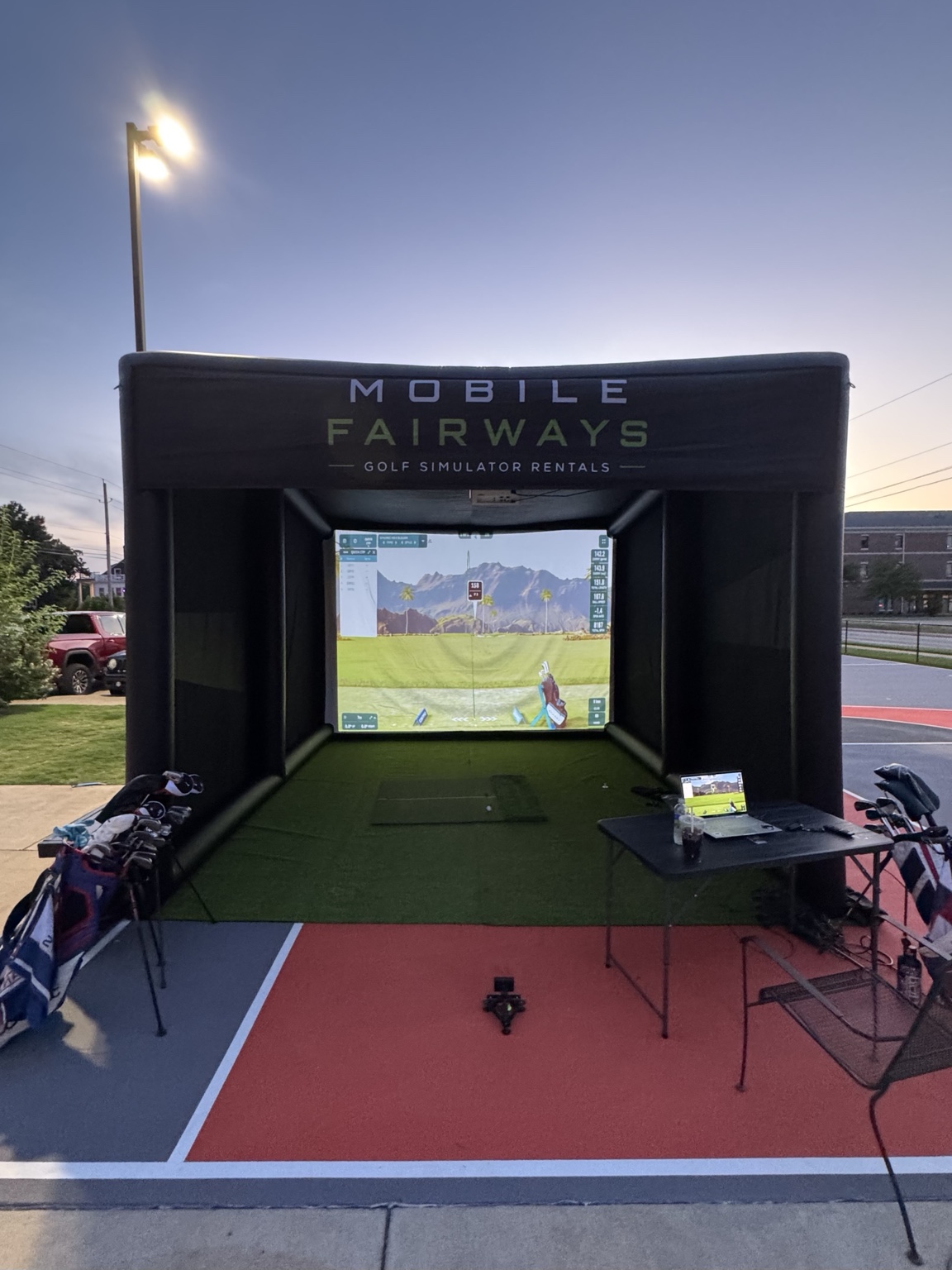 Front view of the Mobile Fairways simulator ready for play at sunset